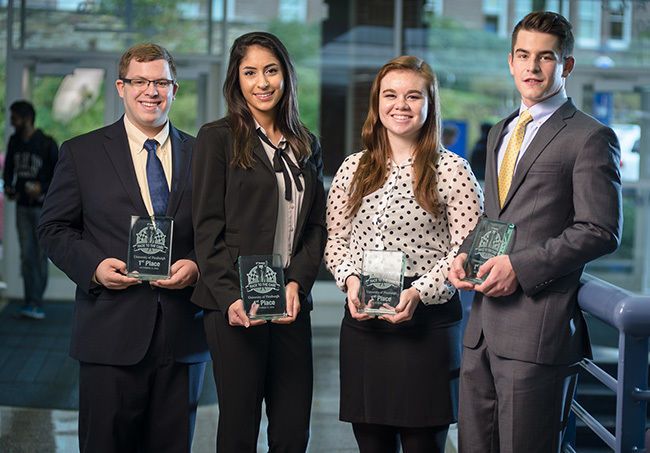 supply chain management competition team holding awards