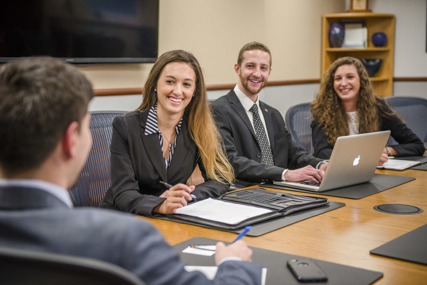 Four Business Students at a board room table