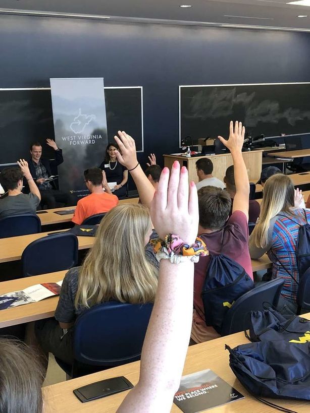alt="Students Raising Hands" />