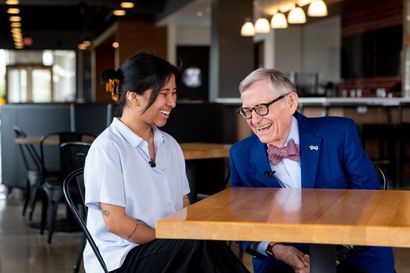 Sara Brinsfield and President Gordon Gee conversing at a table, both smiling