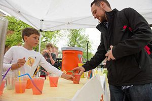 kids selling lemonade to customers