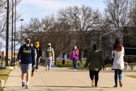 WVU students in Evansdale are shown here practicing varying degrees of COVID-19 risk mitigation strategies such as social distancing and masking. New marketing research from the John Chambers School of Economics shows communications campaigns focused on p