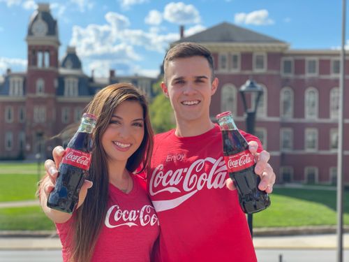 Mason Harp, West Virginia University's New Coca-Cola Ambassador, with past ambassador, Maria Lombardi 